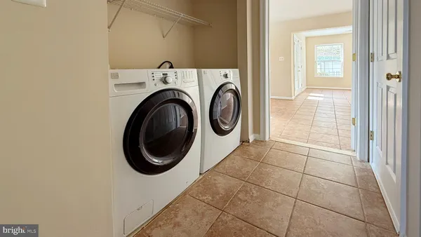 a kitchen with granite countertop a refrigerator a sink dishwasher a stove top oven a refrigerator with wooden floor and cabinets