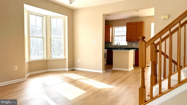 a view of an entryway with wooden floor and a livingroom