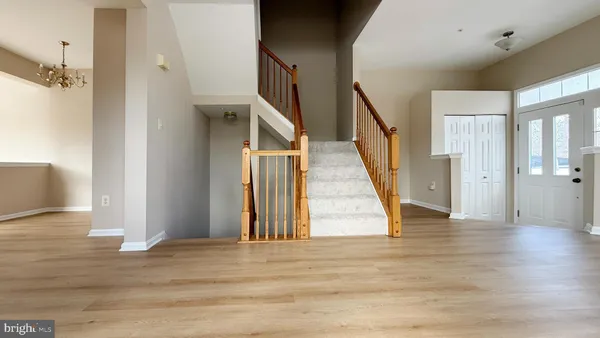 a view of entryway and hall with wooden floor