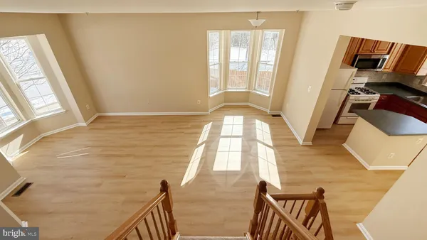 a view of an empty room and wooden floor