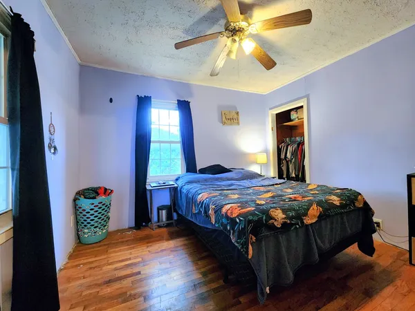 a bedroom with a bed and a chandelier