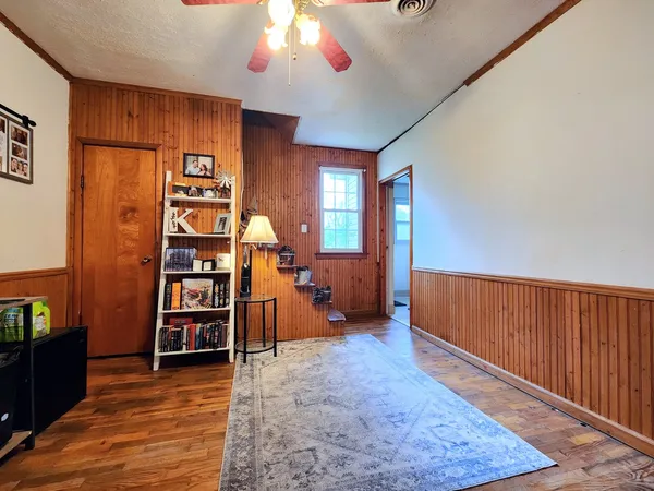 wooden floor in an empty room with a window