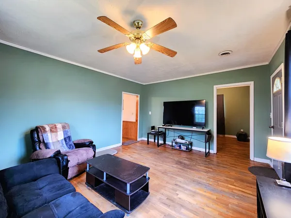 a living room with furniture and a flat screen tv