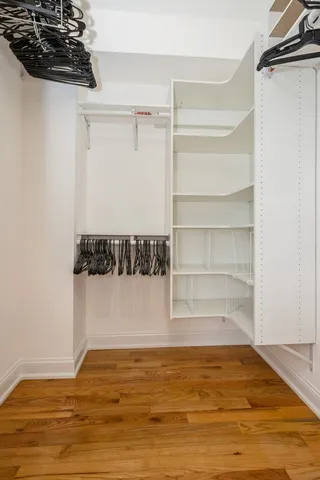 a view of walk in closet with empty racks