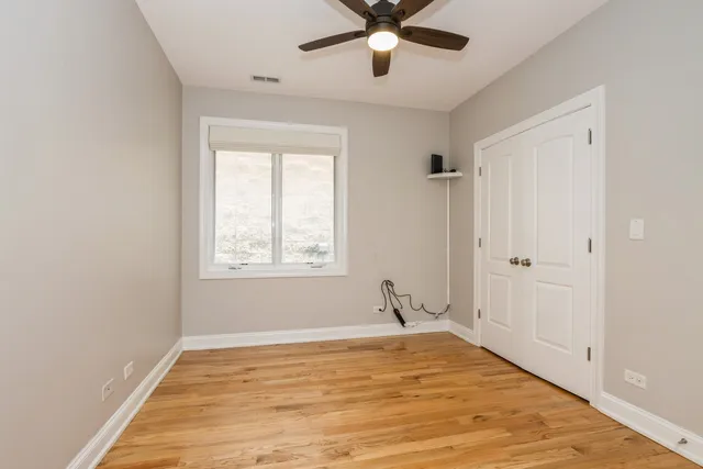 a view of a room with a window and ceiling fan