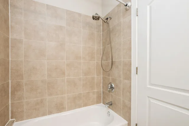 a bathroom with a shower and a bath tub