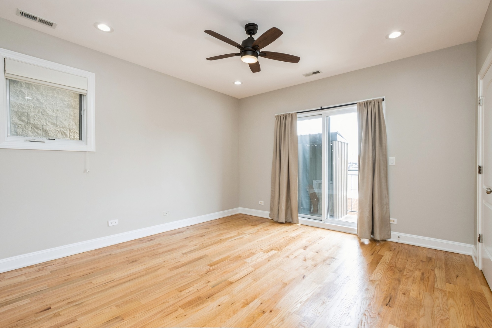 21 East 26th Street, Unit 3 Chicago, IL 60616 - Photo 9 of 21 an empty room with wooden floor and chandelier fan