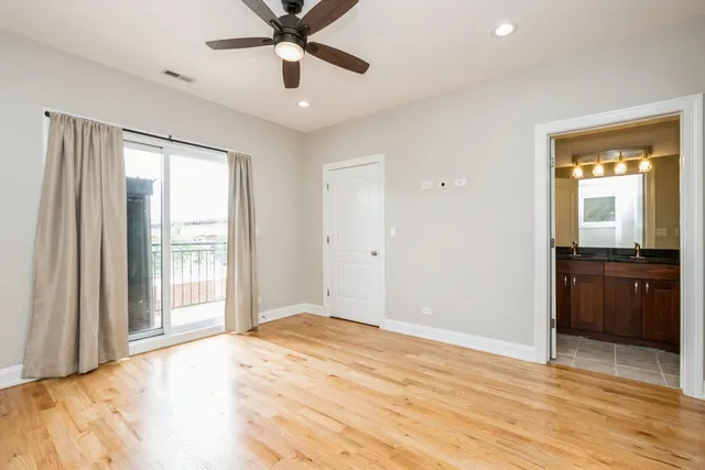 a view of an empty room with a kitchen and a window