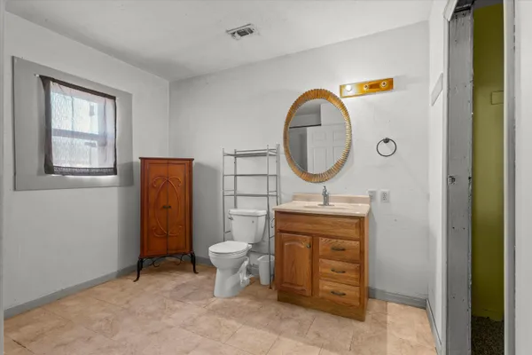 a view of a bathroom with a sink and a mirror