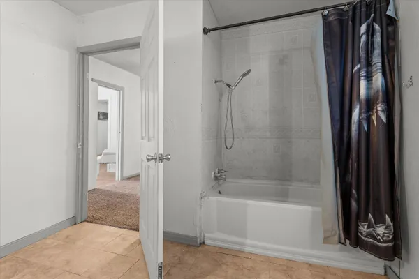 a bathroom with a bathtub and a shower