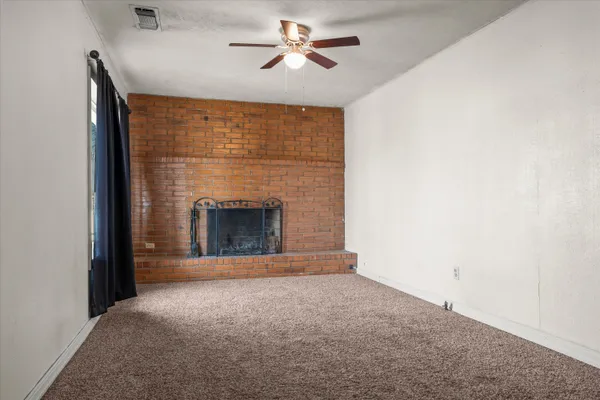a view of empty room with a fireplace