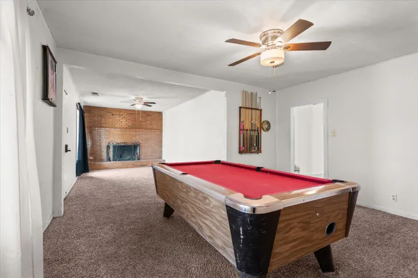a bed room with a bed and a ceiling fan
