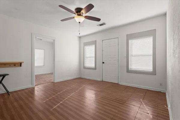 wooden floor in an empty room with a window
