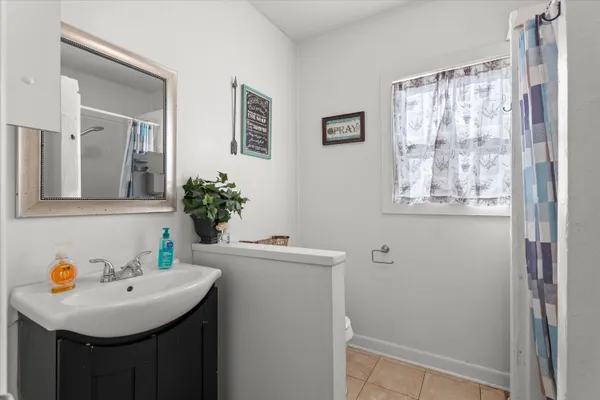 a bathroom with a sink a mirror and a shower