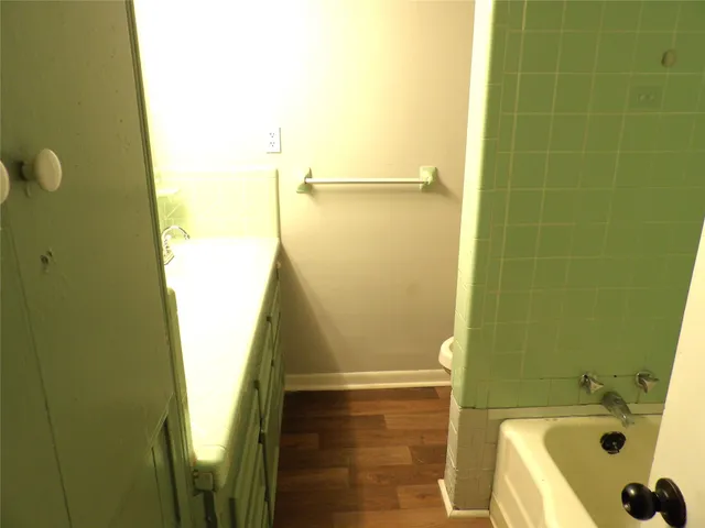 a bathroom with a tub and shower