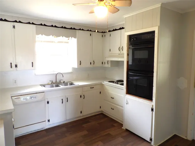 a kitchen with a refrigerator sink and cabinets