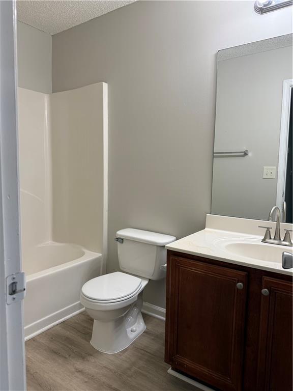 6370 Olmadison Place Atlanta, GA 30349 - Photo 13 of 15 a bathroom with a sink a toilet and shower