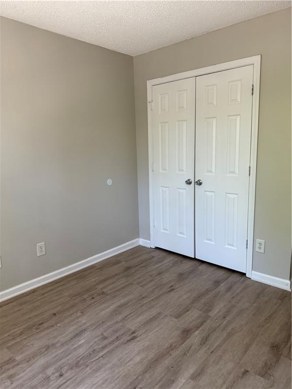 6370 Olmadison Place Atlanta, GA 30349 - Photo 14 of 15 a view of an empty room with wooden floor