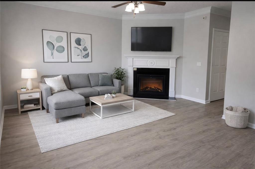 6370 Olmadison Place Atlanta, GA 30349 - Photo 2 of 15 a living room with furniture and a fireplace