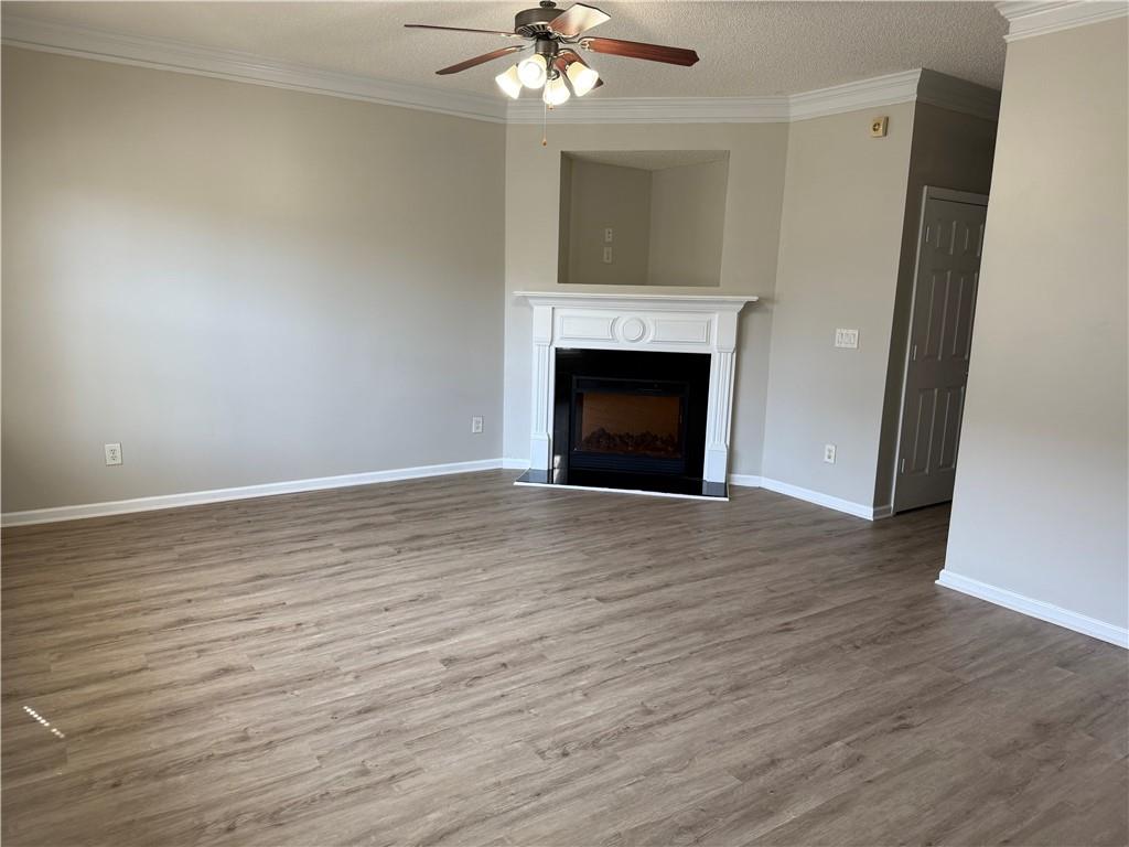 6370 Olmadison Place Atlanta, GA 30349 - Photo 3 of 15 a view of empty room with wooden floor and fireplace