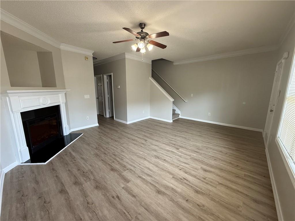 6370 Olmadison Place Atlanta, GA 30349 - Photo 4 of 15 a view of an empty room with wooden floor fireplace and a window
