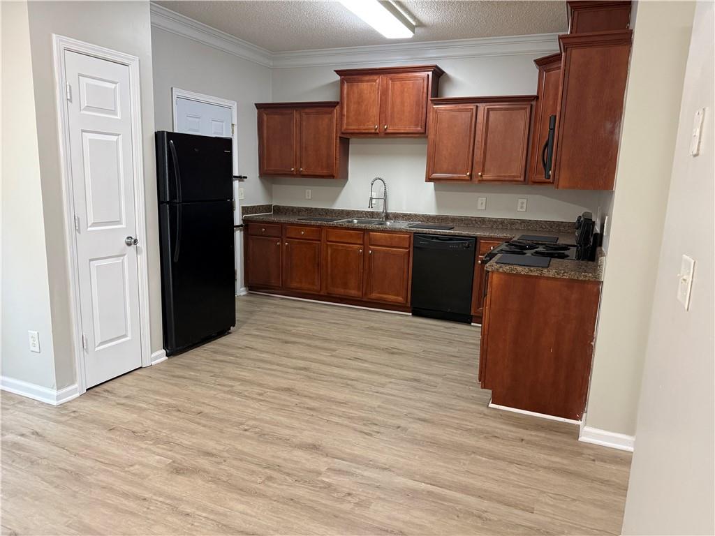6370 Olmadison Place Atlanta, GA 30349 - Photo 6 of 15 a kitchen with stainless steel appliances granite countertop a refrigerator and a stove top oven