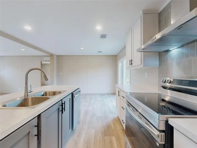 a kitchen with sink and cabinets