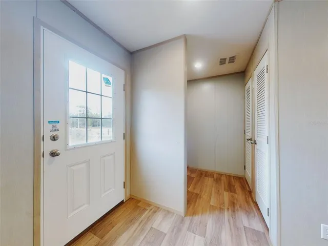 a view of hallway with wooden floor