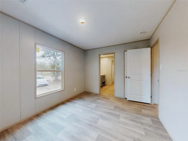 an empty room with windows and closet
