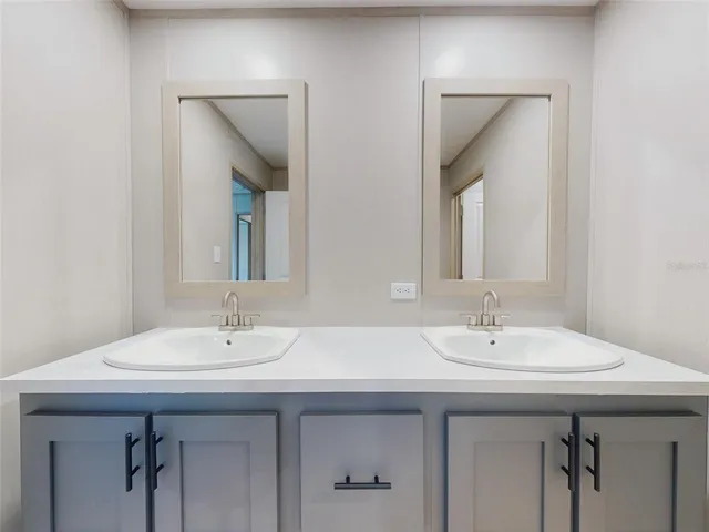 a bathroom with 2 sink and a mirror