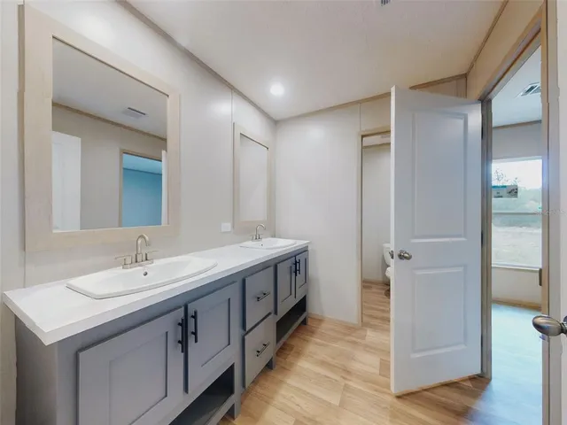 a spacious bathroom with a double vanity sink and a mirror