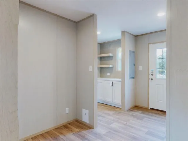 a view of empty room with wooden floor