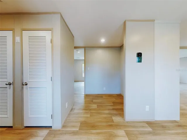 a view of a hallway with wooden floor