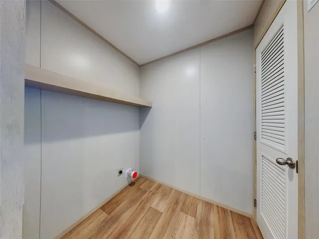 a view of a room with wooden floor and closet