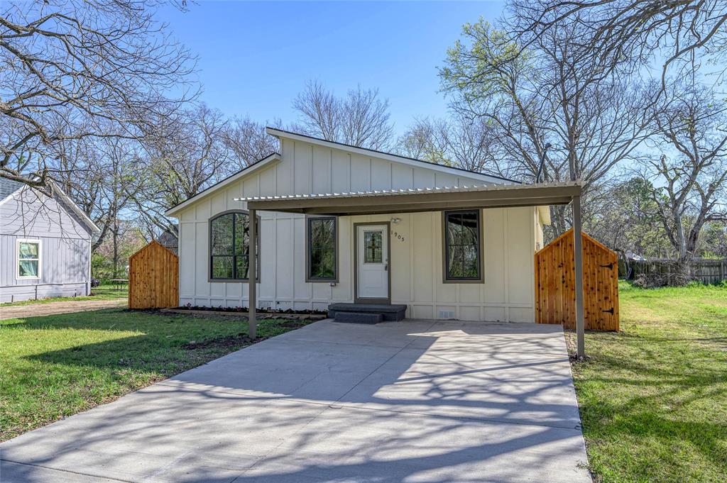 1905 South Walnut Street Sherman, TX 75090 - Photo 1 of 22 a front view of a house with a yard and trees