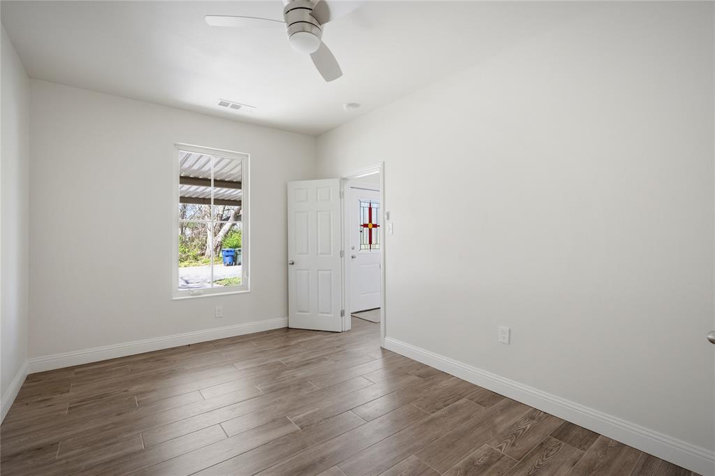 1905 South Walnut Street Sherman, TX 75090 - Photo 11 of 22 a view of an empty room with a window and wooden floor