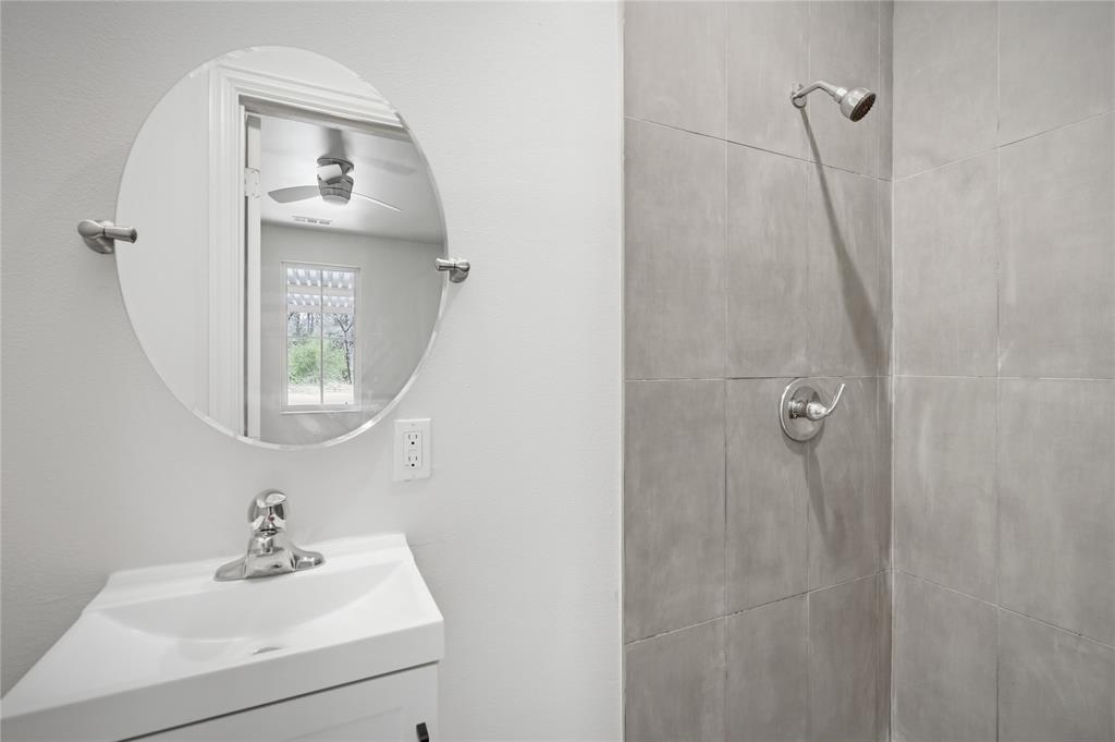 1905 South Walnut Street Sherman, TX 75090 - Photo 12 of 22 a bathroom with a sink a mirror and vanity