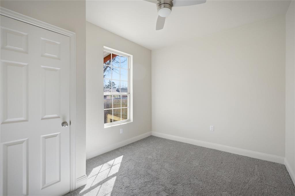 1905 South Walnut Street Sherman, TX 75090 - Photo 13 of 22 an empty room with a window and a fan
