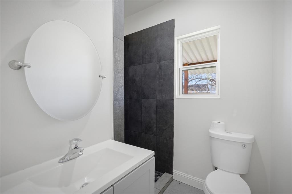 1905 South Walnut Street Sherman, TX 75090 - Photo 15 of 22 a bathroom with a toilet sink and mirror