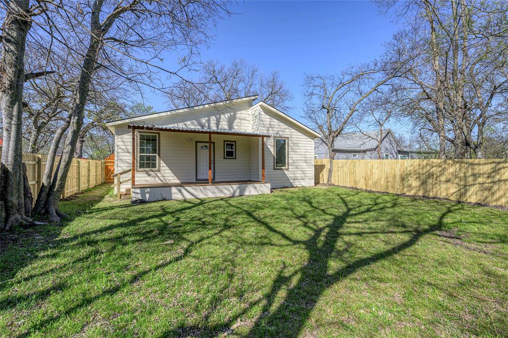 1905 South Walnut Street Sherman, TX 75090 - Photo 20 of 22 a view of a backyard with plants and large tree