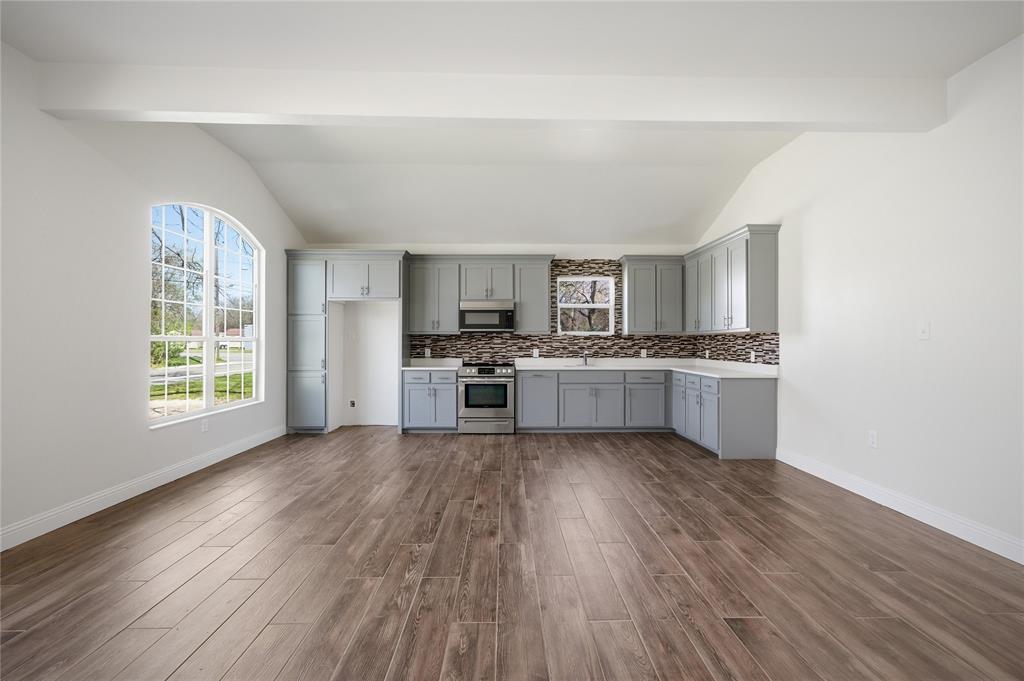 1905 South Walnut Street Sherman, TX 75090 - Photo 6 of 22 a kitchen with stainless steel appliances a refrigerator sink and cabinets