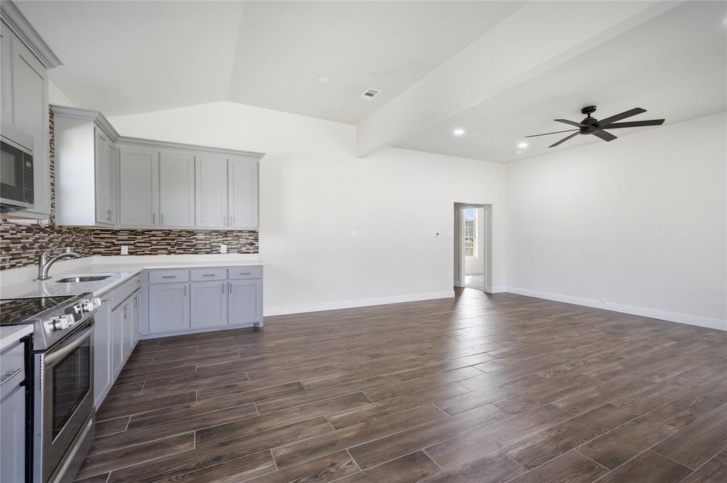 1905 South Walnut Street Sherman, TX 75090 - Photo 8 of 22 a kitchen with stainless steel appliances granite countertop a stove a sink and a refrigerator