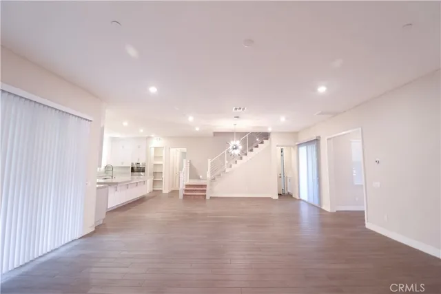 a view of a kitchen with a refrigerator and a sink