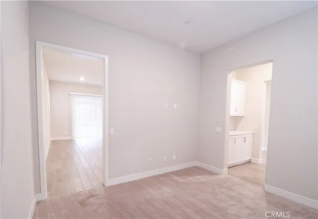 a view of an empty room and a window