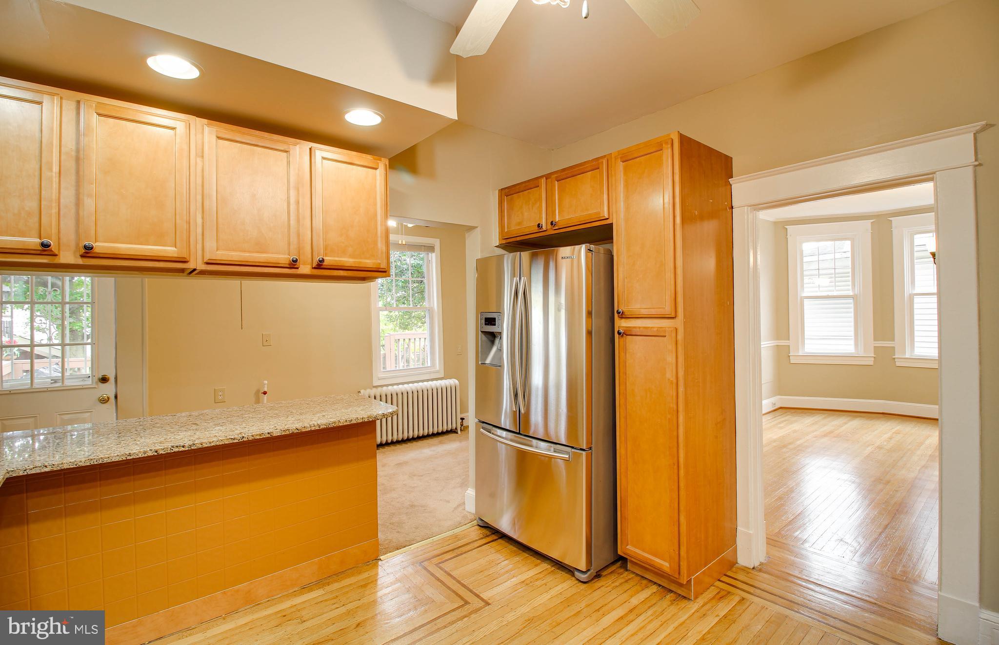 211 Mallow Hill Road Baltimore, MD 21229 - Photo 15 of 49 a view of a refrigerator in kitchen and wooden floor