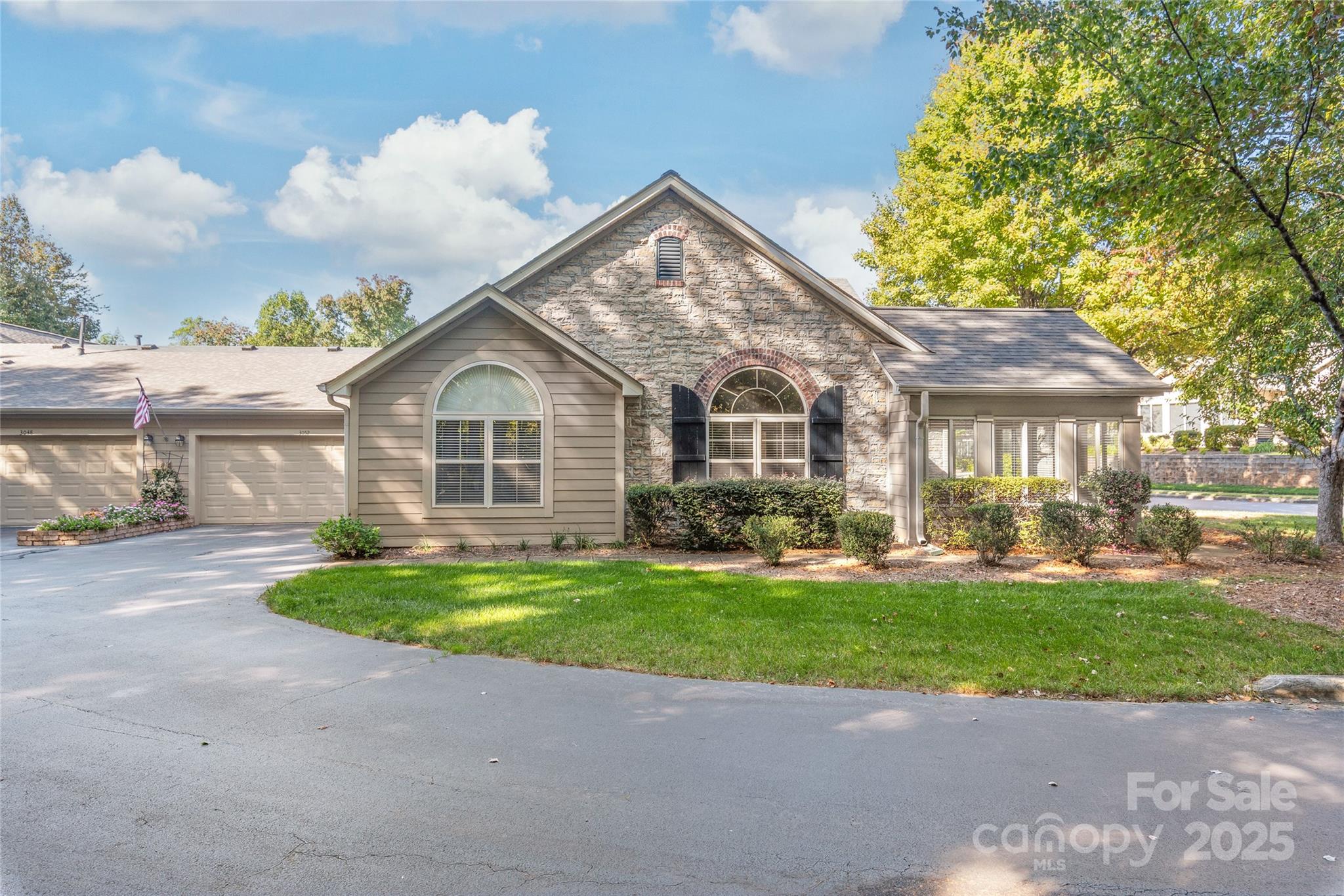 3052 Polo View Lane Matthews, NC 28105 - Photo 1 of 16 a front view of a house with a yard and garage