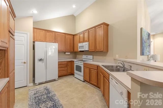 a kitchen with stainless steel appliances granite countertop a refrigerator sink and cabinets