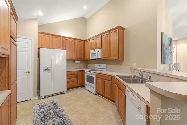 a kitchen with stainless steel appliances granite countertop a refrigerator sink and cabinets