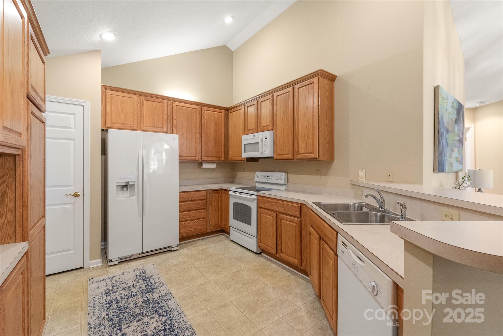 3052 Polo View Lane Matthews, NC 28105 - Photo 11 of 16 a kitchen with stainless steel appliances granite countertop a refrigerator sink and cabinets