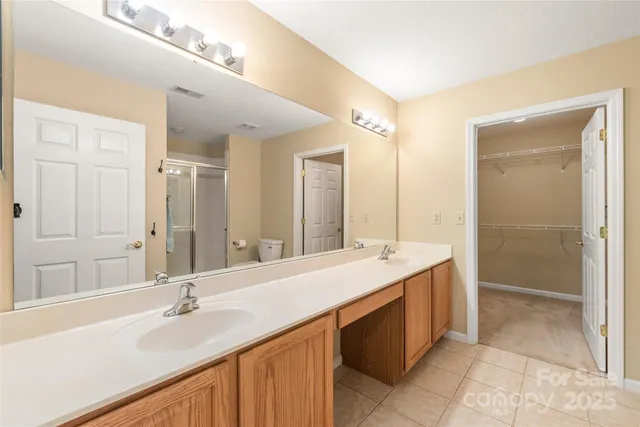 a bathroom with a sink double vanity and a mirror